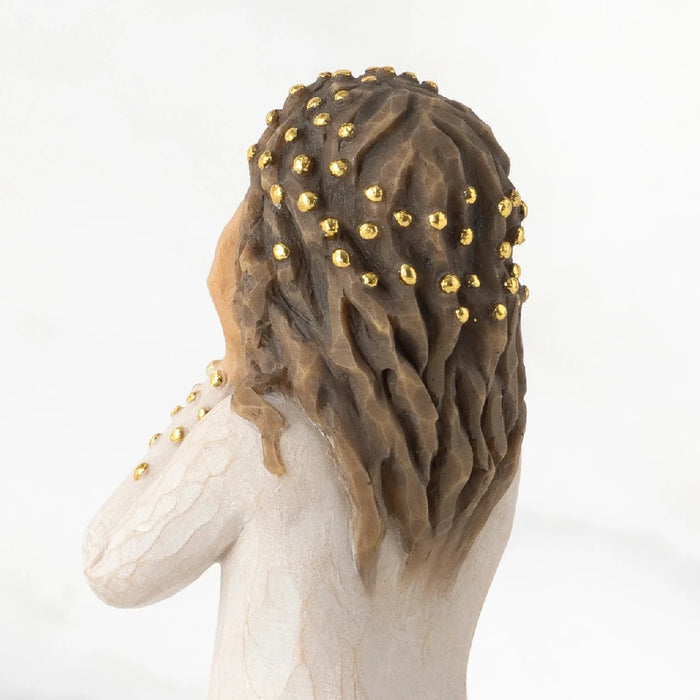 A beautifully crafted figurine representing a woman in a white dress, emphasizing her graceful demeanor and intricate design.