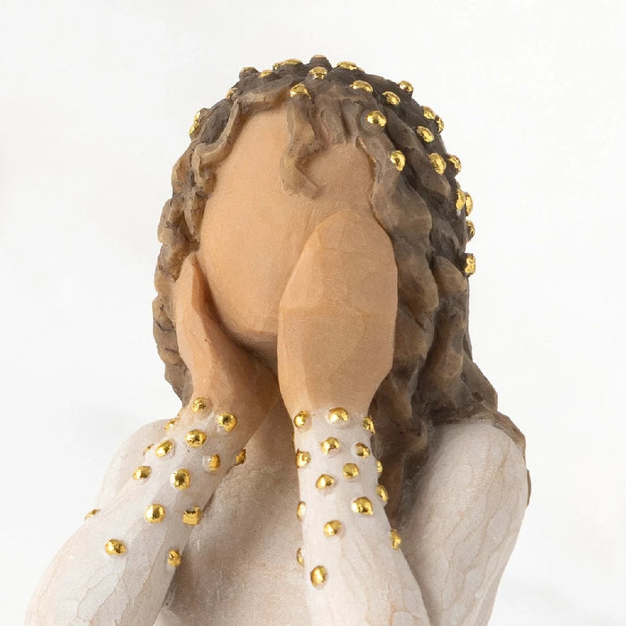 A detailed figurine of a woman in a white dress, showcasing her elegance and the artistry involved in its creation.