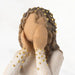 A detailed figurine of a woman in a white dress, showcasing her elegance and the artistry involved in its creation.