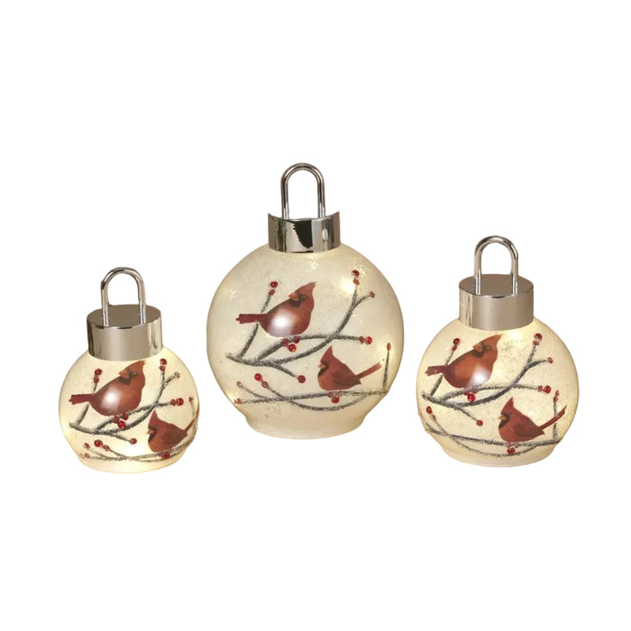 This Gerson lighted glass holiday cardinal ornament features a vibrant red cardinal design set in decorative glass. 