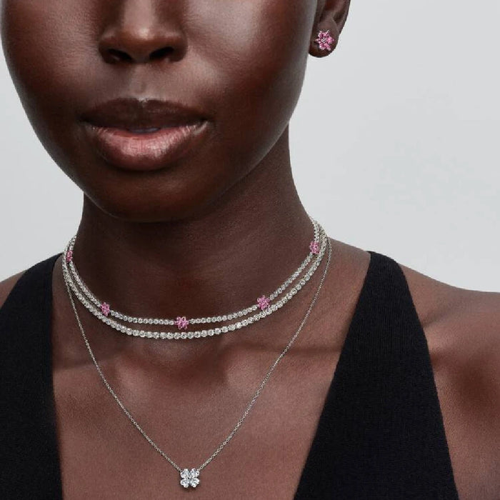 Delicate pink flower stud earrings embellished with diamonds, offering a charming and sophisticated look.