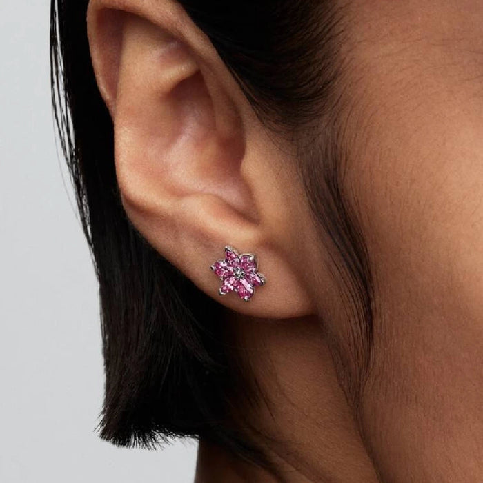 Beautiful pink flower stud earrings with diamond accents, combining floral beauty with luxurious sparkle.