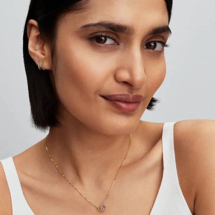PANDORA Beaded Huggie Earrings in 14k gold plating with delicate bead detailing and a sparkling center stone