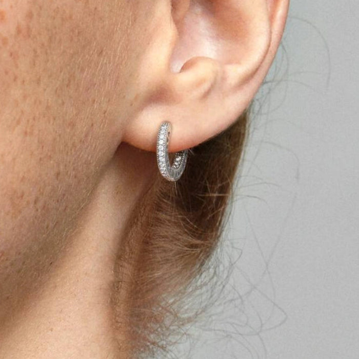 This Pandora Pavé Heart Hoop Earrings features a sparkling pavé heart crafted in sterling silver. 
