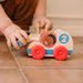 Three wooden toys with cheerful child faces, crafted to inspire imagination and playfulness in children.