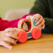 A set of three wooden toys, each with a child's face, designed to be fun and visually appealing for young users.
