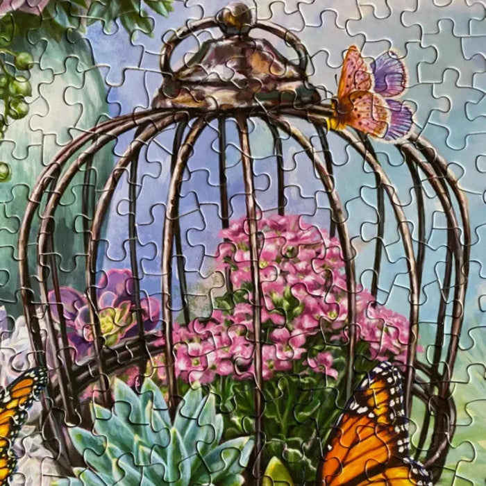 Jigsaw puzzle with a birdcage, flowers, and butterflies