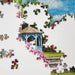 Jigsaw puzzle with a garden scene including a gazebo and flowers on a white background