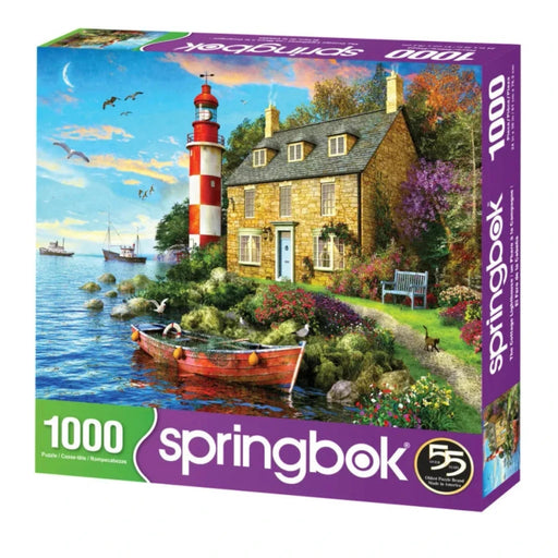 Springbok 1000-piece puzzle box with a scenic design of a lighthouse and house by the water.