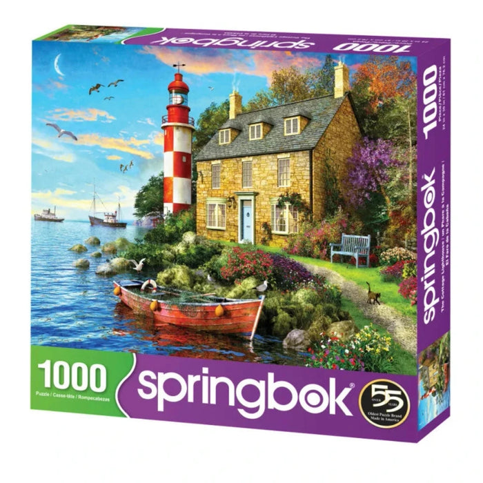 Springbok 1000-piece puzzle box with a scenic design of a lighthouse and house by the water.