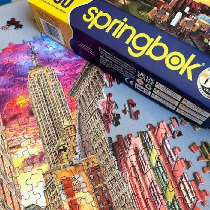 Partial puzzle of a cityscape with Springbok packaging in the background