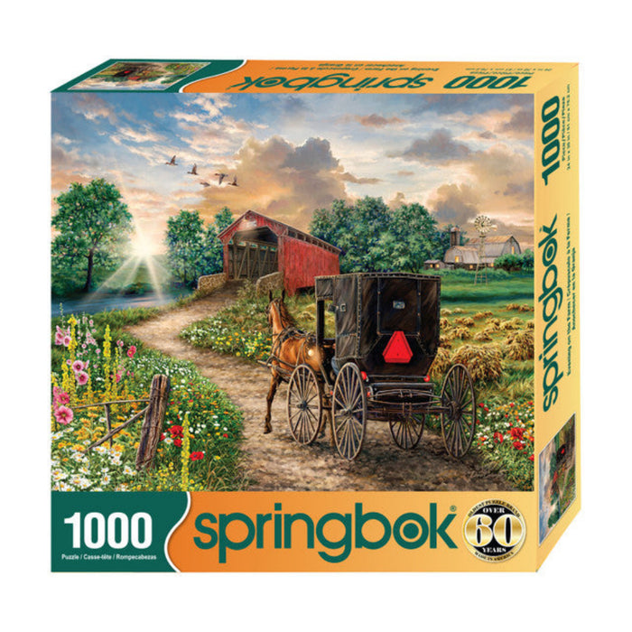 Springbok 1000-piece puzzle box with a horse-drawn carriage and covered bridge scene.