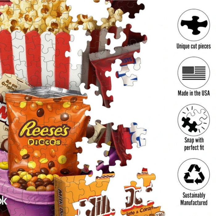 Box of Springbok candy with various candy bars and a bucket of popcorn on a white background