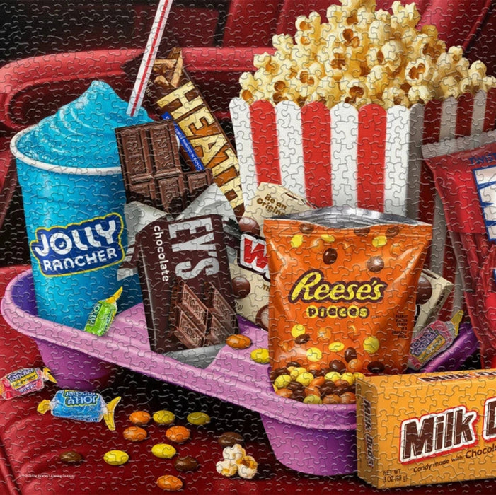 Box of Springbok candy with various candy bars and a bucket of popcorn on a white background