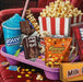 Box of Springbok candy with various candy bars and a bucket of popcorn on a white background
