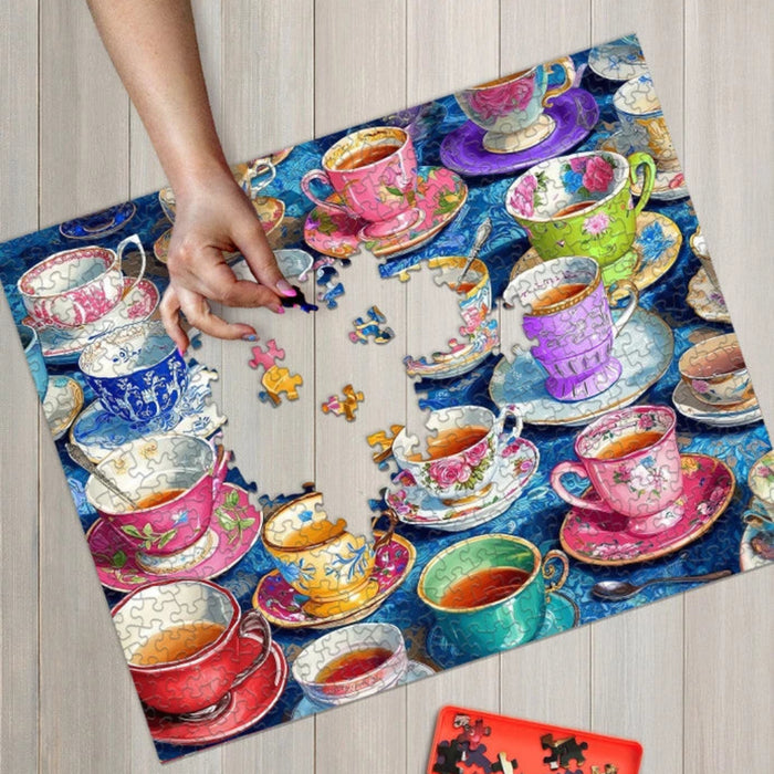 Jigsaw puzzle with colorful teacups and saucers on a wooden surface