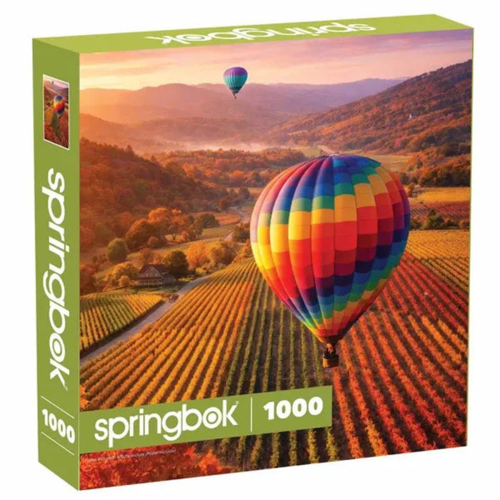 This Springbok Vineyard Balloon 1000-Piece Jigsaw Puzzle captures a beautiful vineyard scene with a colorful hot air balloon floating above the landscape.