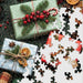 The Springbok Christmas Wrapping 500 Piece Jigsaw Puzzle features vibrant, festive artwork bursting with ribbons, bows, and colorful gift wrap.