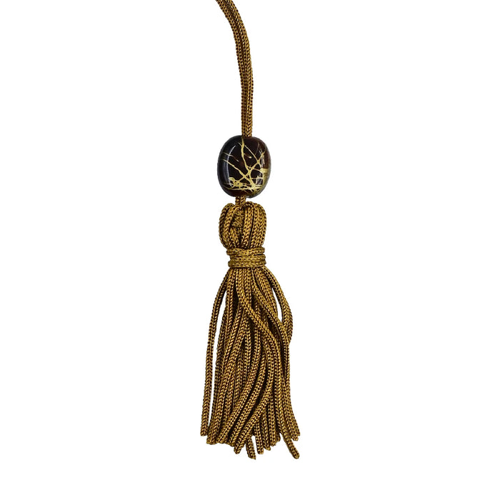 A book displaying a tassel and a name tag, emphasizing its personalized touch.