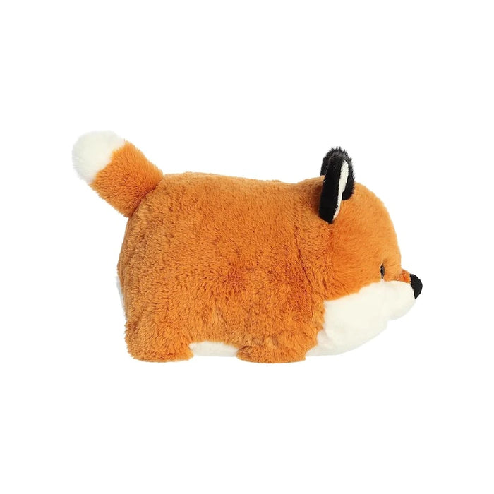 A stuffed fox lying on its side, featuring detailed stitching and a cozy appearance.