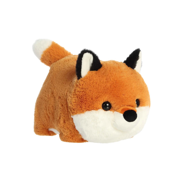 A soft, plush fox toy positioned on its side, highlighting its vibrant orange color and friendly face.