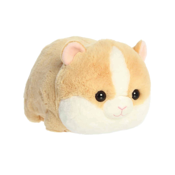 A plush hamster is positioned on a white background, highlighting its cute expression and fluffy texture.