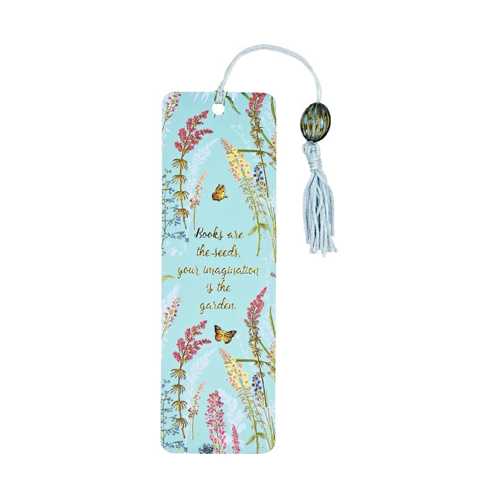 A colorful butterfly-shaped bookmark resting on an open book page, adding a whimsical touch to reading.