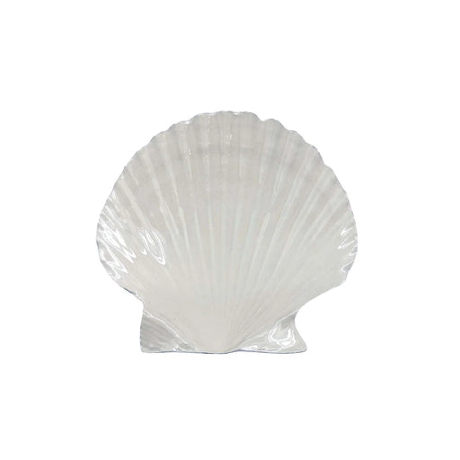 A white shell-shaped dish on a plain white background, emphasizing its elegant design and simplicity.