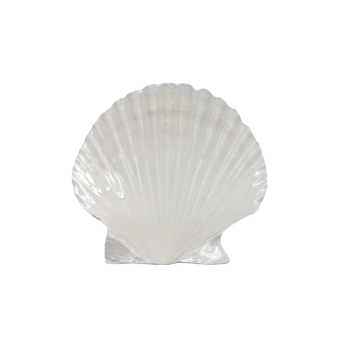 A white shell-shaped dish on a plain white background, emphasizing its elegant design and simplicity.