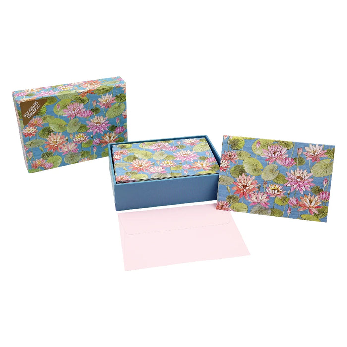 A blue box with a floral card and envelope inside, showcasing a charming design suitable for special occasions.