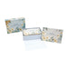 A thank you card with a floral motif and its envelope, elegantly arranged on a plain background.