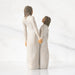 Two figurines holding hands on a white background