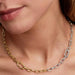 Close-up of a woman wearing the Pandora Two-Tone Link Chain Necklace featuring two openable links and a carabiner clasp.
