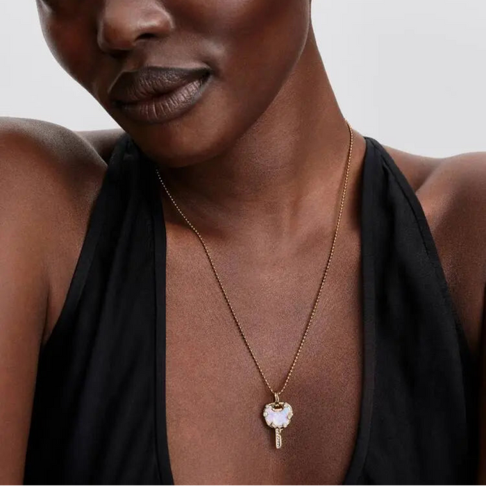 Woman wearing the Pandora Ball Chain Necklace in 14k gold plating around her neck.