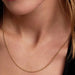 Pandora Ball Chain Necklace in 14k gold plating worn on a woman’s neck.