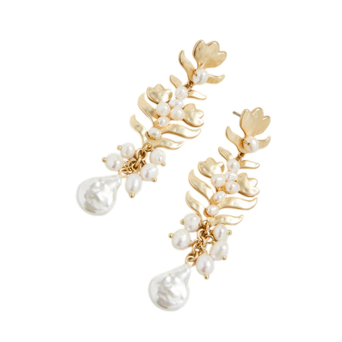 A pair of gold leaf-shaped earrings adorned with small pearls and hanging pearl drops.


