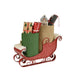 Decorative sleigh with Christmas-themed items including a green bag, red box, and small house on a white background.