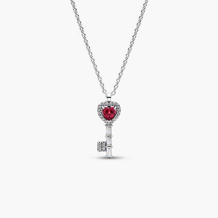 Close-up of the Pandora Elevated Heart Key Collier Necklace in sterling silver showing a heart key pendant with red crystal and sparkling halo on a white background.