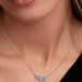 Close-up of a woman wearing the Pandora Halo Heart Trilogy Collier Necklace with three heart-shaped stones and halo detailing.