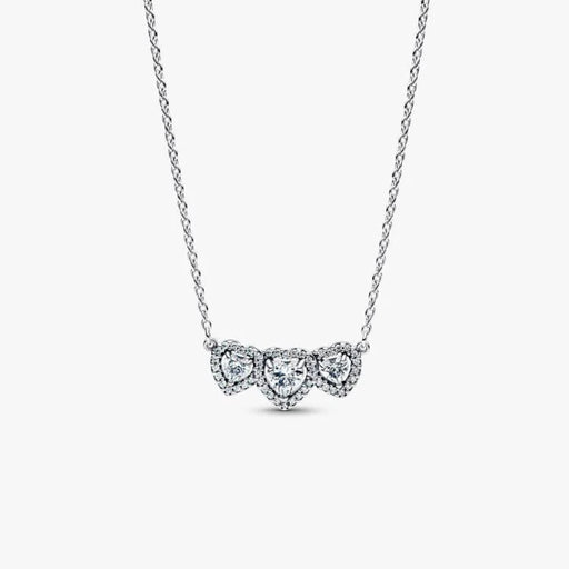 Close-up of the Pandora Halo Heart Trilogy Collier Necklace in sterling silver showing three heart-shaped cubic zirconia with a sparkling halo on a white background.