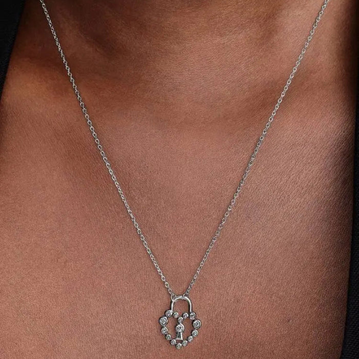 Close-up of a woman wearing the Pandora Sparkling Heart Padlock Pendant Necklace with a heart-shaped cubic zirconia design and central padlock.