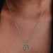 Close-up of a woman wearing the Pandora Sparkling Heart Padlock Pendant Necklace with a heart-shaped cubic zirconia design and central padlock.