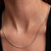 Close-up of a woman’s neck wearing the Pandora Ball Chain Necklace, a modern sterling silver beaded chain.