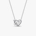 Silver necklace with a heart and butterfly shaped charm on a white background
