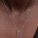 A pink flower pendant set with diamonds, beautifully showcased on a slender chain.