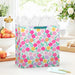 Extra‑deep floral gift bag with bright multicolor flowers displayed on a table beside a greeting card