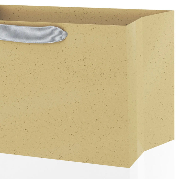 Close‑up of large two‑tone gift bag showing kraft brown and white design