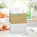 Large kraft‑and‑white two‑tone gift bag displayed on a table beside a greeting card