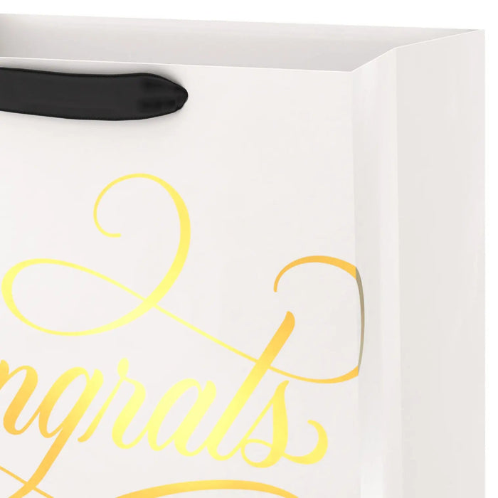 Close‑up of cream and gold “Congrats” gift bag