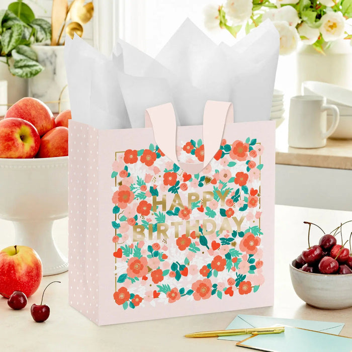 Floral “Happy Birthday” gift bag  shown on a table with a card